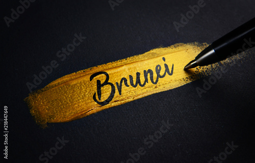 Brunei Handwriting Text on Golden Paint Brush Stroke