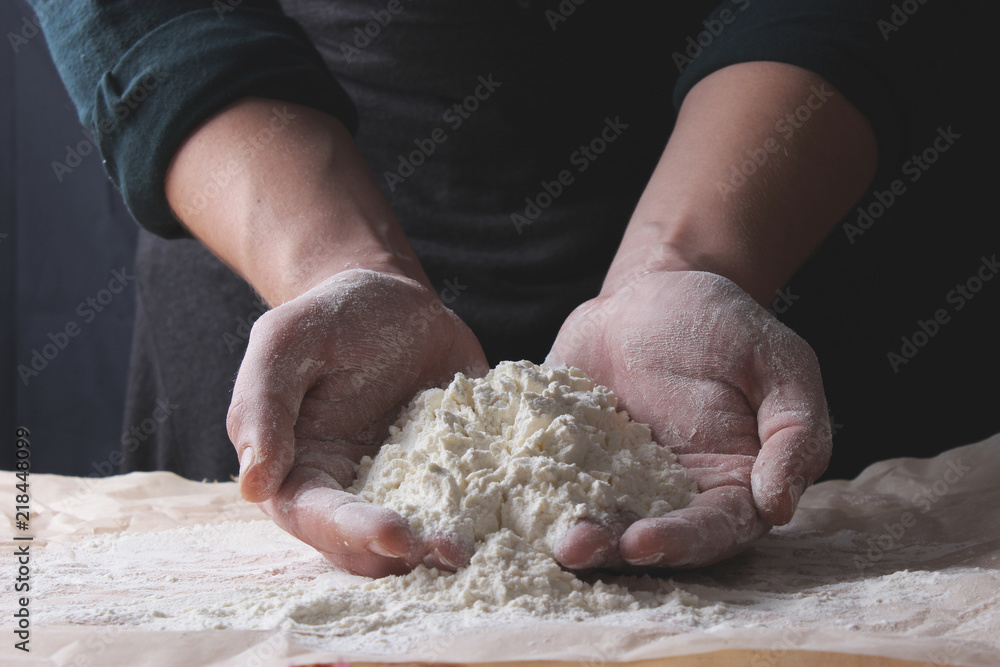 Hands of cook with flour on a dark background. Hands of cook with flour on a dark background.