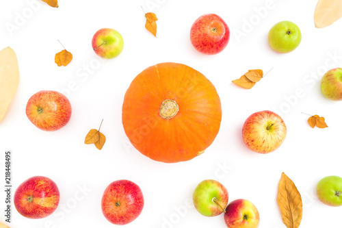 Autumn background with fall dried leaves, apples and orange pumpkin on white background. Flat lay, top view
