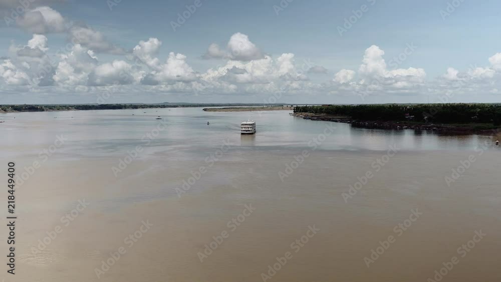 long distance view of a river cruise ship reaching port long distance view of a river cruise ship reaching port