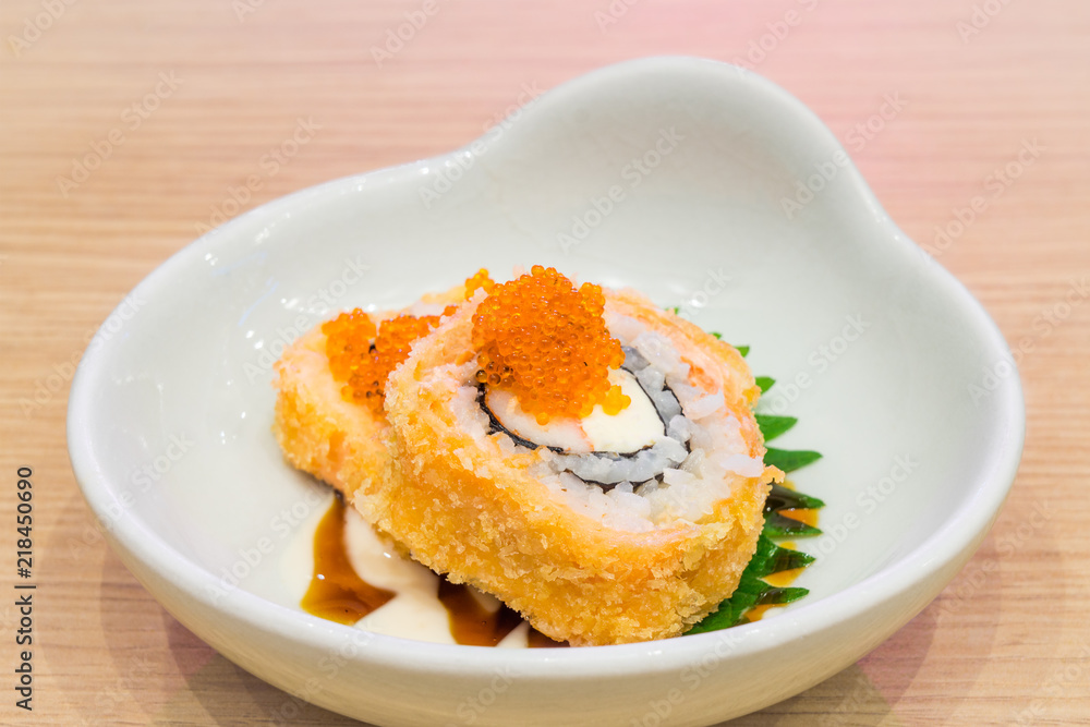 Bowl of Crispy Deep Fried Roll Sushi topped with small fish eggs. It is a new modern Japanese meal and delicacy. Bowl of Crispy Deep Fried Roll Sushi topped with small fish eggs. It is a new modern Japanese meal and delicacy.