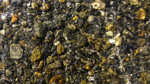 Glossy Stones in a Crystal Clear River