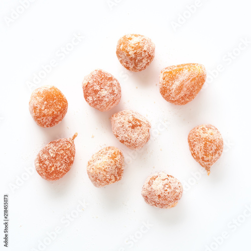 Dried sweet kumquat under powdered sugar isolated on white background. Top view.