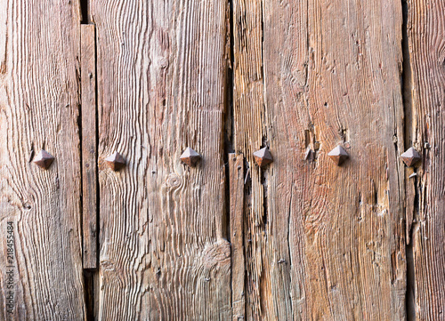 old wooden door with iron forged rivets photo