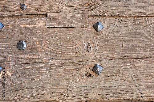 old wooden door with iron forged rivets photo