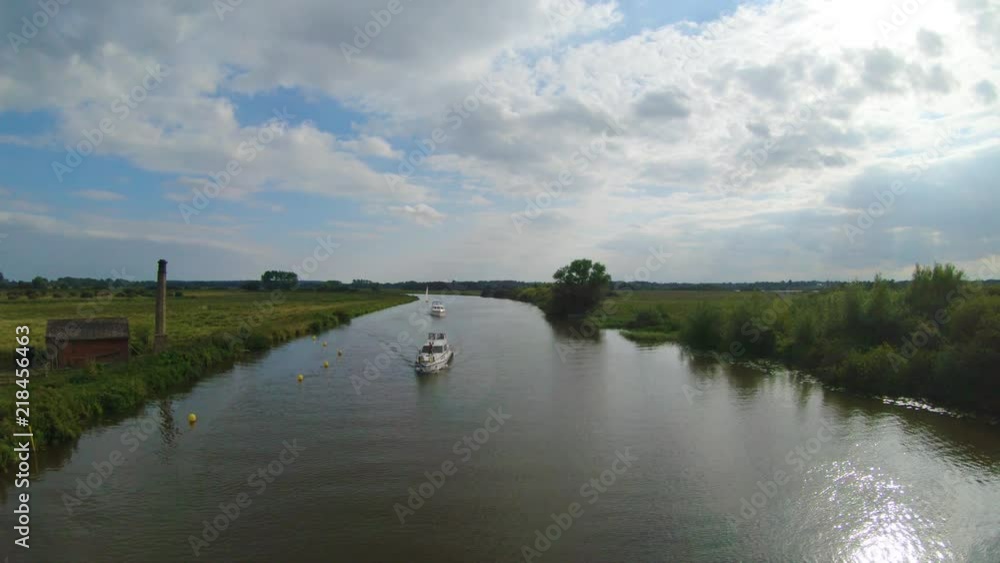 Two cruising boats along river Yare in Norfolk Broads. Two cruising boats along river Yare in Norfolk Broads.