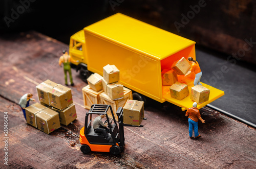 miniature warehouse workers forklift carrying goods box to semi truck with trailer .logistics warehouse freight transportation concept