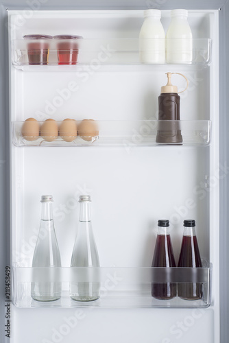 Open fridge full of fresh fruits and vegetables