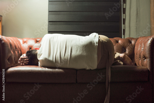 Portrait of sleeping thoughtful man on vintage sofa in the living room photo