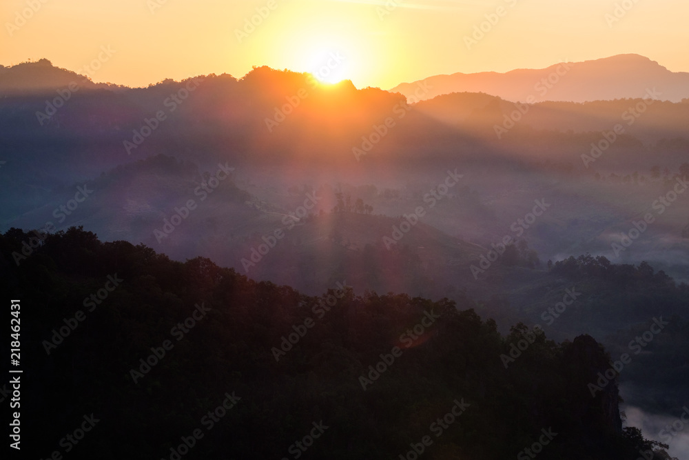Fototapeta premium Sunrise shine on mountain in fog valley
