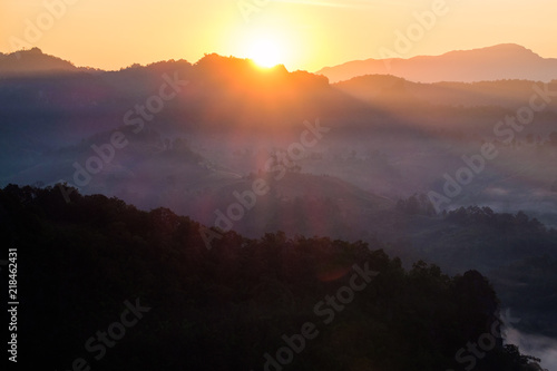 Sunrise shine on mountain in fog valley
