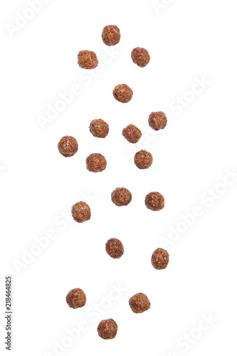 Chocolate cereal balls falling isolated on white background.