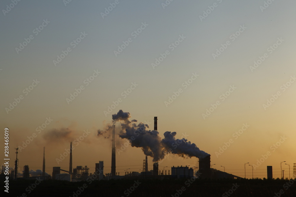 Industrial plant equipment in the sunset Industrial plant equipment in the sunset