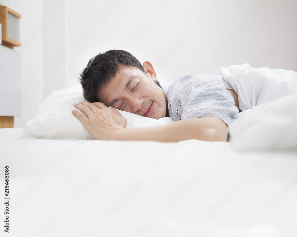 Attractive young man sleeping in his bed Attractive young man sleeping in his bed