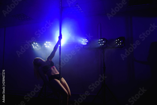 attractive sexy woman pole dancer performing