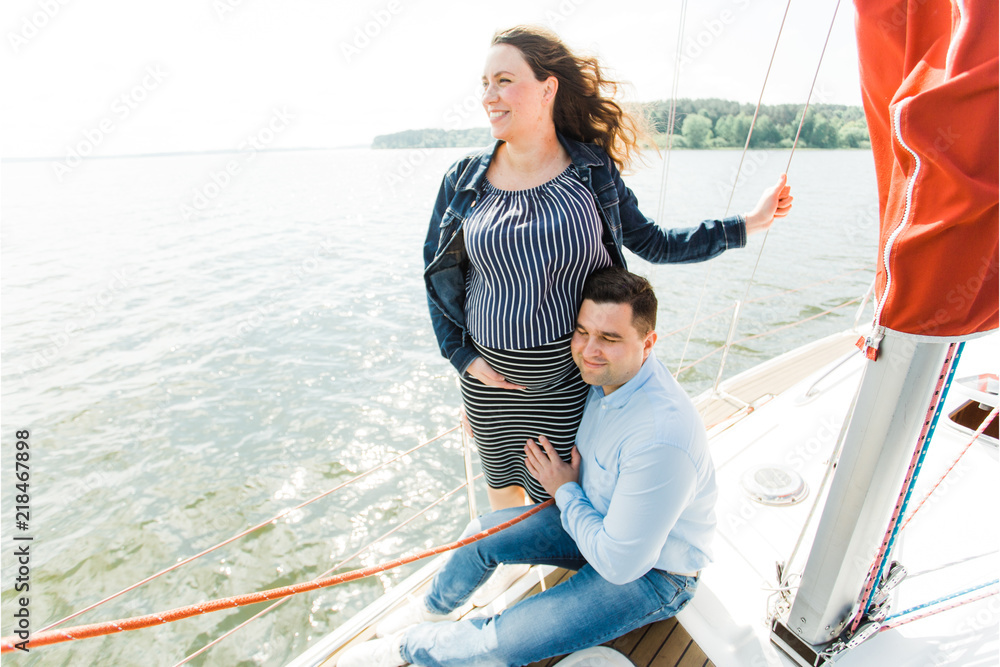 Pregnant woman with husband on yacht. Happy pregnancy concept. Young family on vacation. Pregnant woman with husband on yacht. Happy pregnancy concept. Young family on vacation.