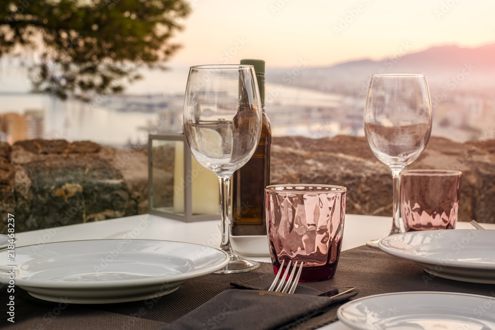 Fototapeta premium The close-up table in outdoor restaurant with great view over the Malaga city, Costa del sol, Spain