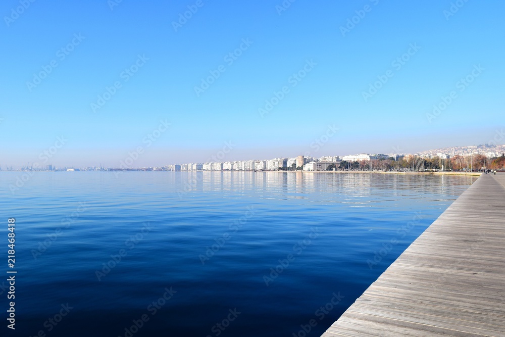 Wide shot of Thessaloniki seafront. Blue sea and White Tower background