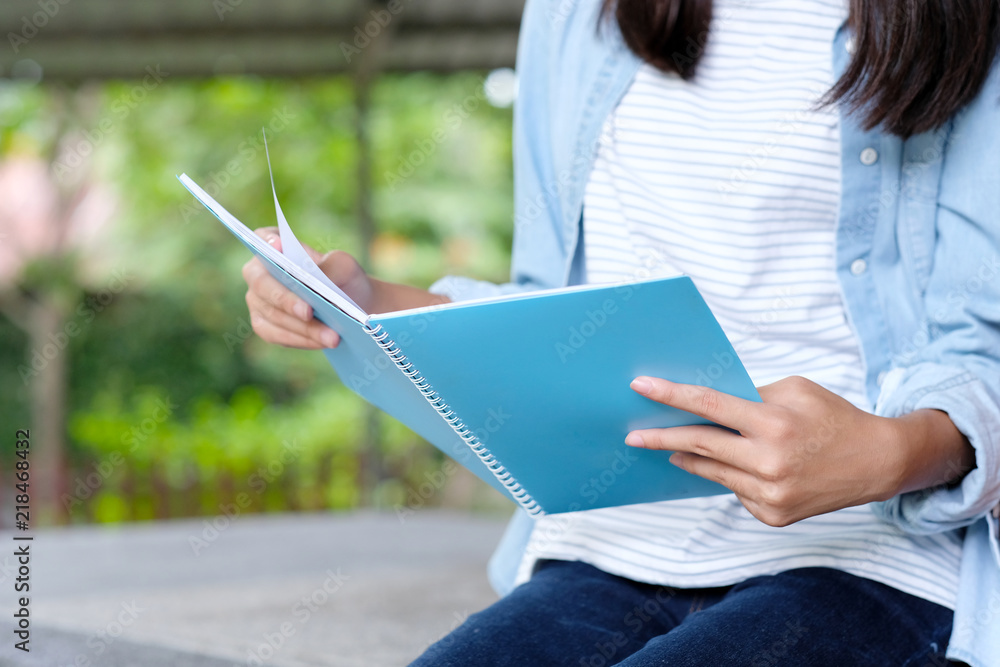 Obraz premium Student girl sitting and reading book, education, back to school concept