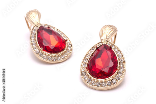 gold earrings with ruby drops isolated on white
