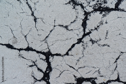 Cracks in white painted paved of roads