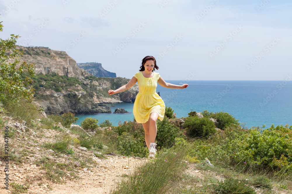Girl running against seascape