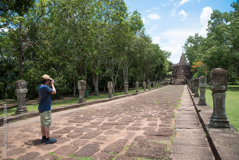 Tourist man shooting photo of PRASAT HIN PIMAI, historic,ancient castle of generality in NAKHON RATCHASIMA Thailand a kind of Khmer architect art decorated in the Buddhist temple,pavilion,temple hall