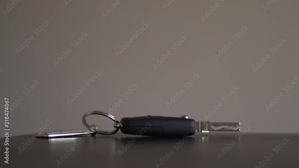 Man putting car key on a table coming home from work. Man putting car key on a table coming home from work.