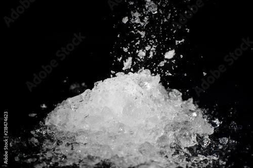 Pile of crushed white ice on black background