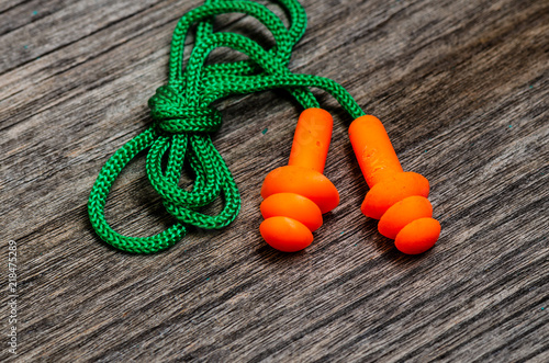 Earplug to reduce noise on a wooden background