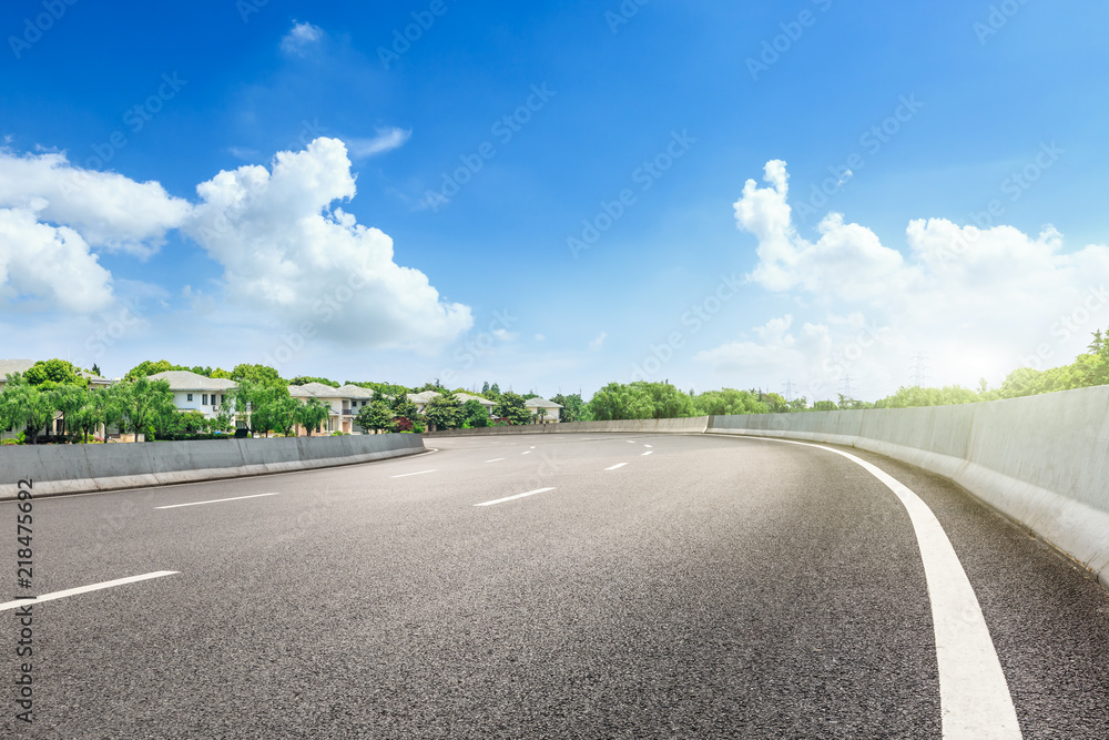 Asphalt road and apartment building scene in the suburbs of the city Asphalt road and apartment building scene in the suburbs of the city