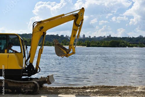 excavator on city beach