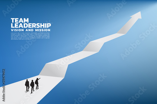 Silhouette of a team leader look up to top of graph. Concept of teamwork, leadership, Goal, Mission and Vision, growth arrow.