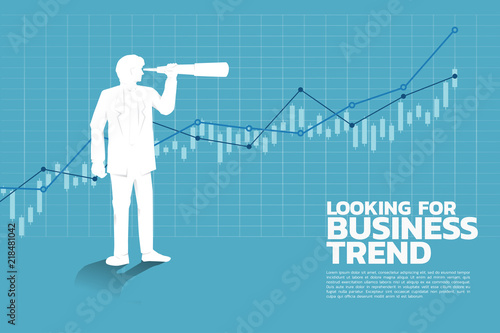 Silhouette of businessman looking through telescope to business trend graph. business concept.
