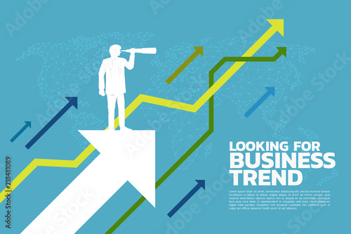Silhouette of businessman looking through telescope to business trend graph. business concept.