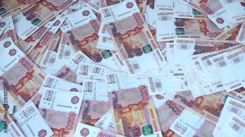 Many Russian banknotes of 5000 rubles are on the table. Background made of money photo