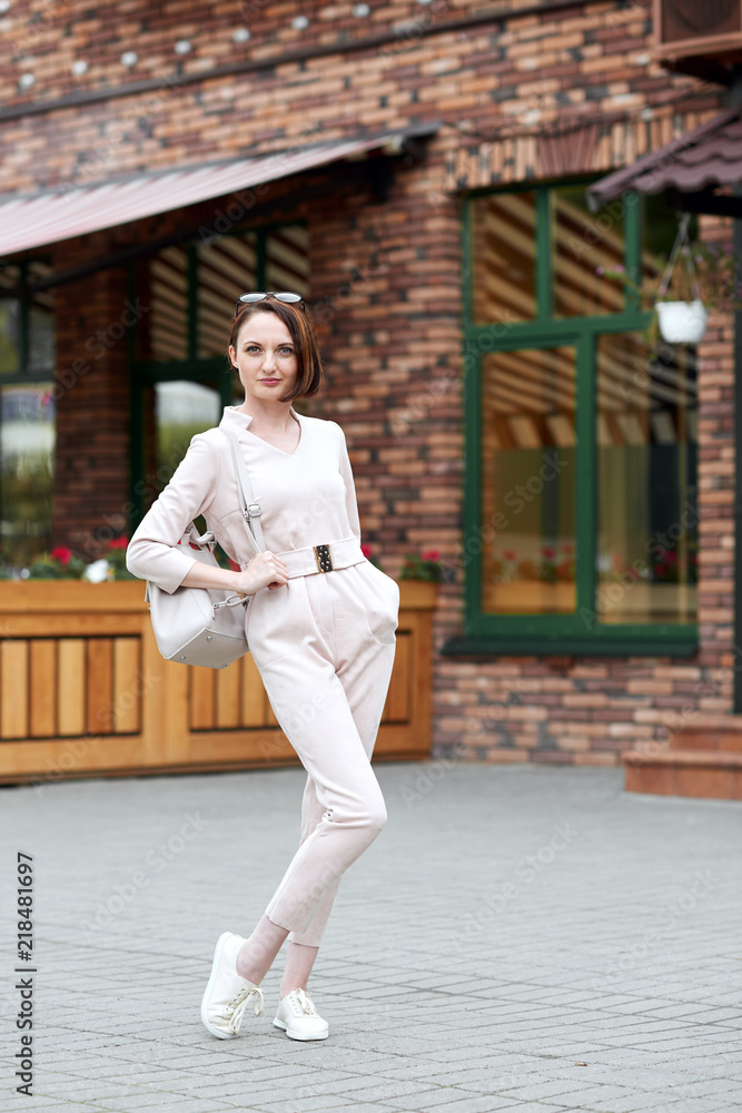 fashionable young girl posing in the street fashionable young girl posing in the street