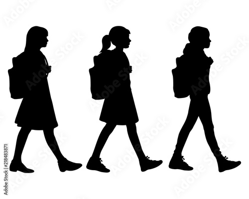 Three isolated silhouette of girls going to school