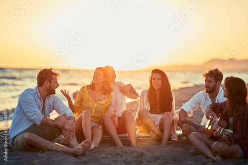 Friends enjoyment together at the beach.Group of friends having a great time together at the beach. © luckybusiness