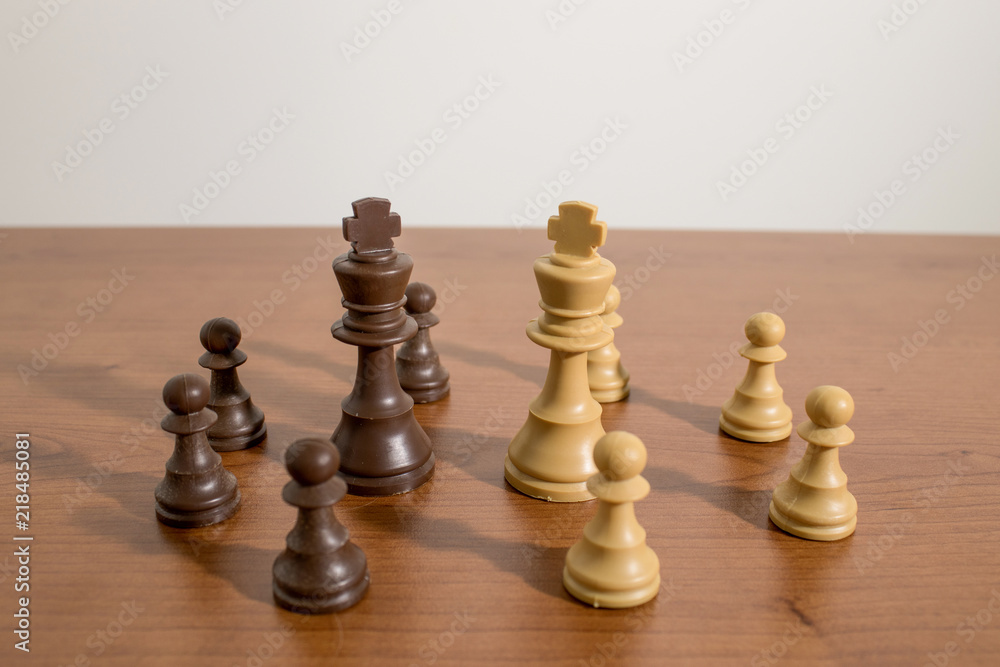 Chess, king pieces on a decorated wood table Chess, king pieces on a decorated wood table