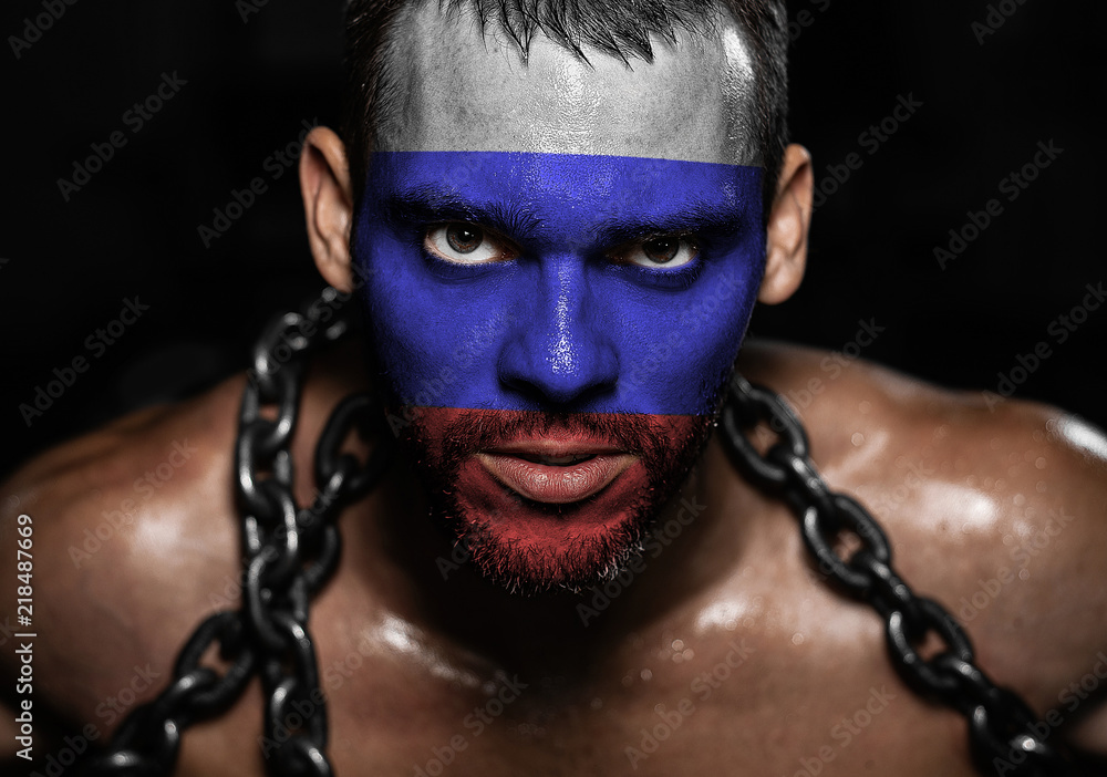 Russian flag on the face of a young man