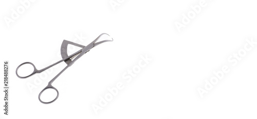 Dental caliper on white background. This instrument has calibrated scale and is used to measure the size of teeth. Closeup