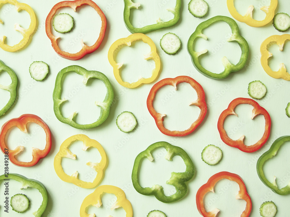 Slices of colorful paprika and cucumbers making pattern. Slices of colorful paprika and cucumbers making pattern.