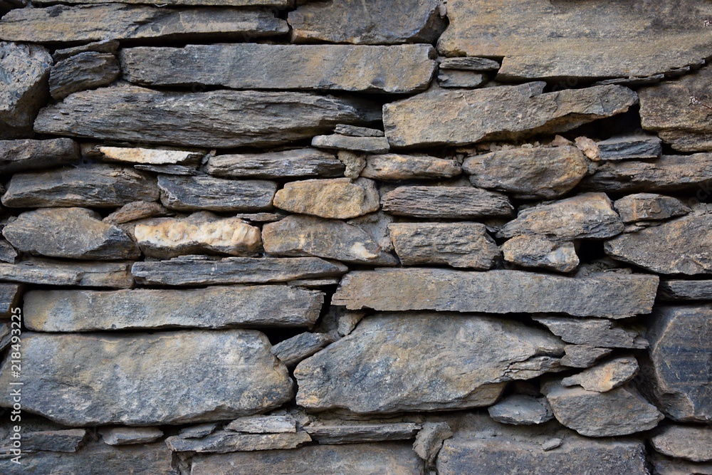 Ancient brick gray coloured raw made of stone wall Ancient brick gray coloured raw made of stone wall