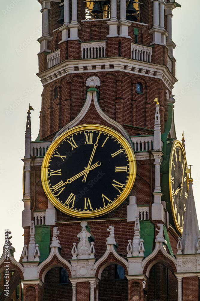 Center of the capital of Russia. Spasskaya towers with chimes in Moscow Kremlin on Red Square in evening light.