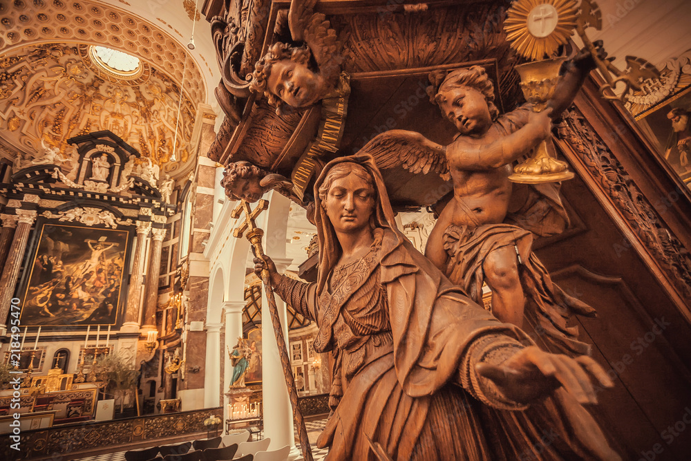Angels and Mother of God witj cross, wooden statue in 17th century catholic church Saint Charles Borromeo, Belgium