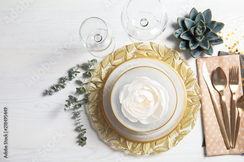 Elegant table setting on light background, top view
