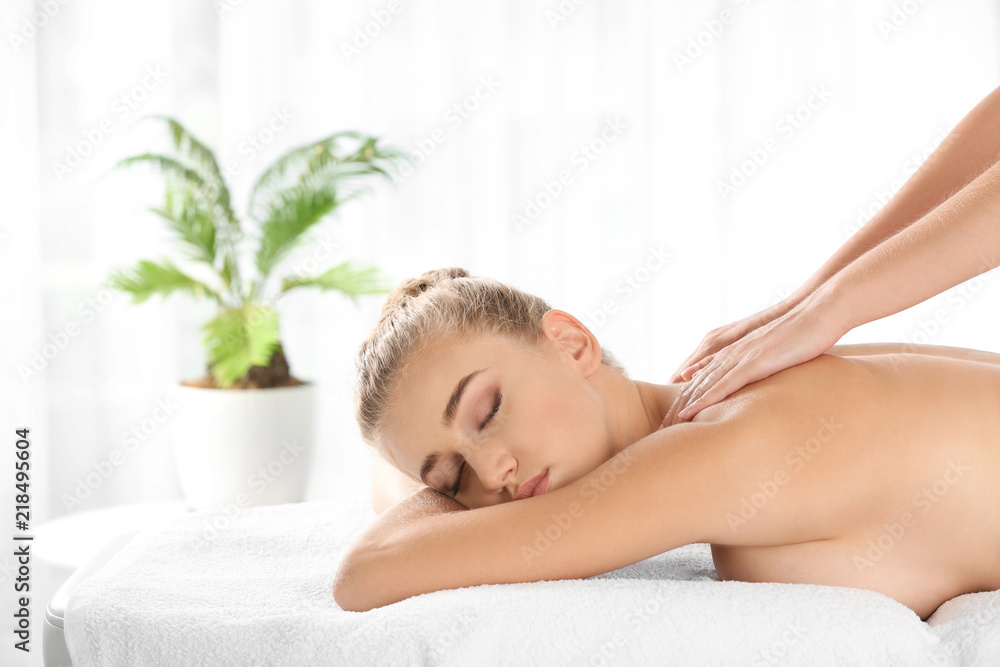 Fototapeta premium Relaxed woman receiving back massage in wellness center