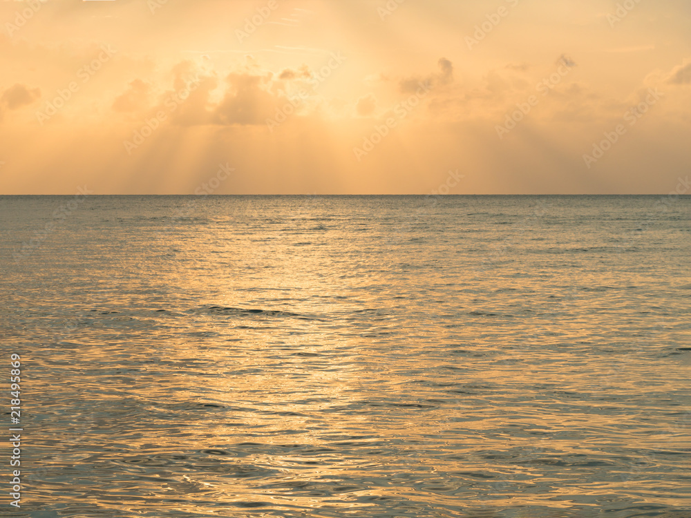 Fototapeta premium Sunset background. Inspirational nature calm sea reflect with beautiful sky twilight evening golden orange cloud dramatic sunset.