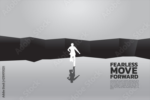 silhouette of businessman running to jumping over the gap. concept of business challenge and courage man